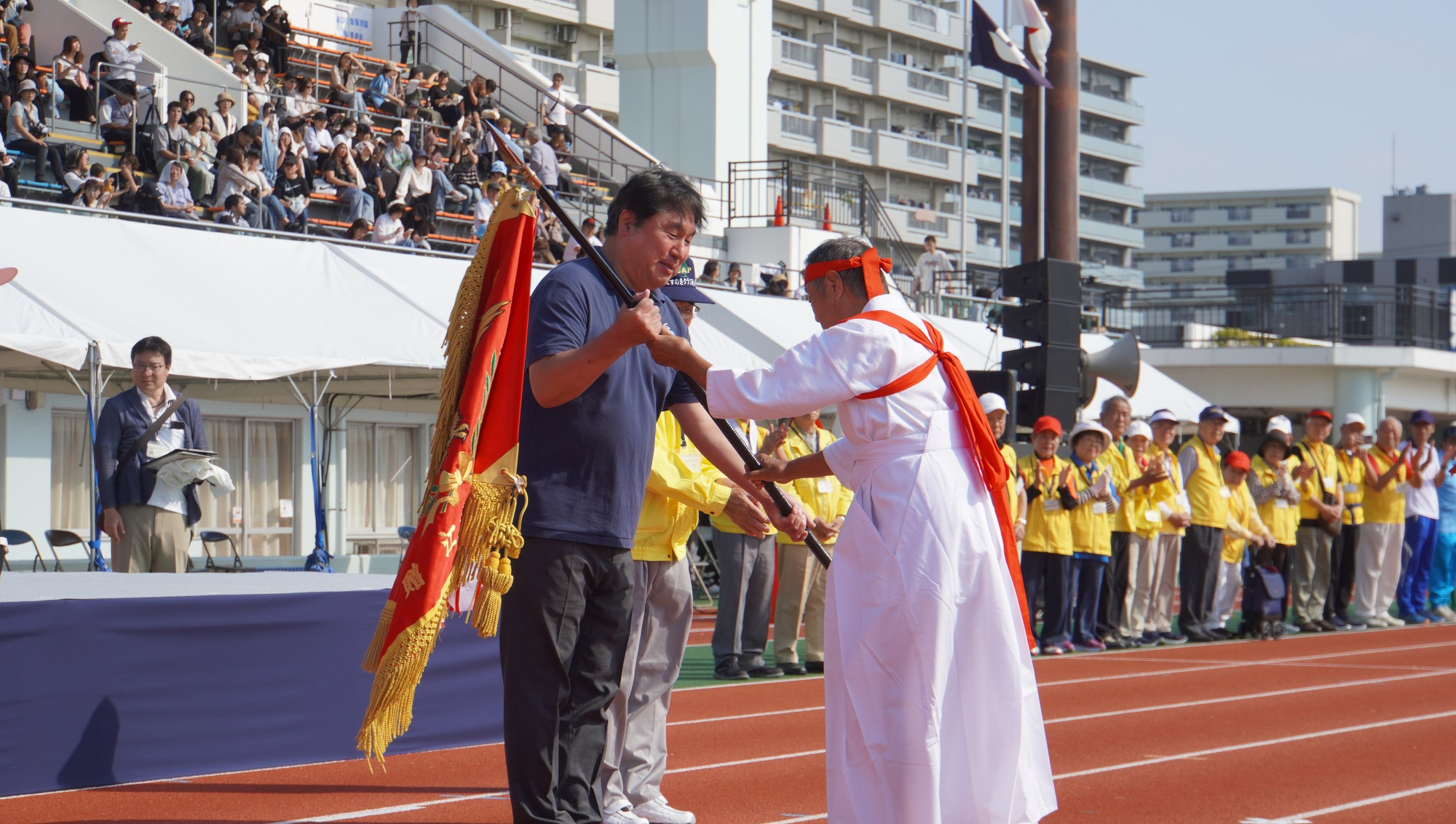 赤組団長から優勝旗を受け取る区長